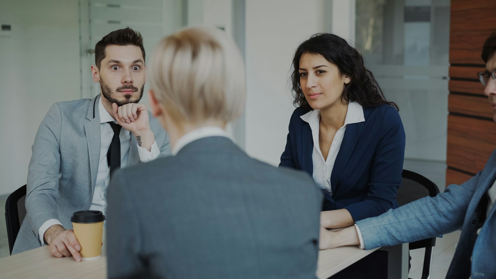 Business team chatting around a table in a modern office